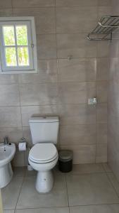 a bathroom with a toilet and a sink at Cabaña Patagónica in El Calafate