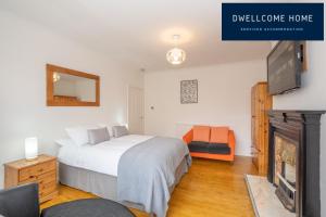 a bedroom with a bed and a fireplace and a tv at Dwellcome Home Ltd 5 Bed 2 and half Bath Aberdeen House - see our site for assurance in Aberdeen