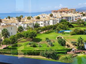 a view of a city with houses and a park at Casa Alegria - Laguna Beach in Torrox Costa