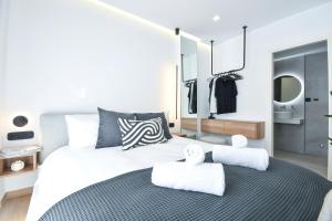 a bedroom with a large bed with towels on it at Luxury Downtown Apartment C1 in Thessaloniki