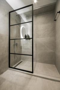 a shower with a glass door in a bathroom at Luxury Downtown Apartment C1 in Thessaloniki