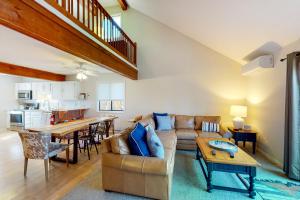 a living room with a couch and a table at Kingswood 12H in White River Junction