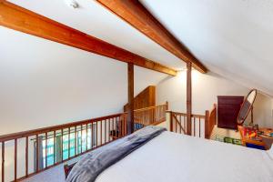 a bedroom with a large bed and a staircase at Kingswood 12H in White River Junction
