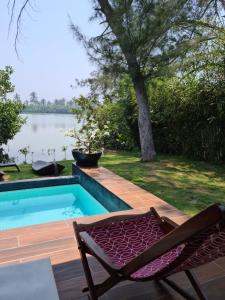 - une piscine avec une chaise à côté de l'eau dans l'établissement Isla Tajín, à Tuxpan