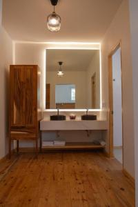 a bathroom with a sink and a large mirror at NaNa Vida CDMX in Mexico City