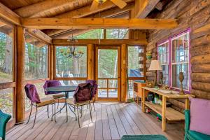 a dining room of a cabin with a table and chairs at Wood Road Retreat in Quechee