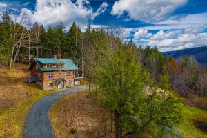 an aerial view of a log house in the woods at Wood Road Retreat in Quechee