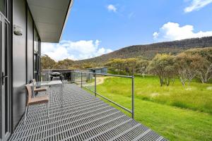 a balcony of a house with a view of a field at Ecocrackenback 3 Sustainable chalet close to the slopes in Crackenback