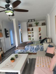 a living room with a bed and a couch at Playa del Ingles Estudio LOS MOLINOS 205 in Maspalomas