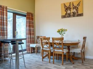 a dining room with a table and chairs at The Farmhouse At Lane Foot in Tallentire