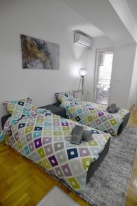 ein Wohnzimmer mit einem Bett und einem Sofa in der Unterkunft Modern & Cozy near City Center with Balcony, free Parking and coffee in Skopje