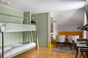 a room with a bunk bed and a table and chairs at Best Western Hotell Hudik in Hudiksvall