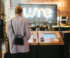 a woman standing in front of a counter with a computer at U&Me; BW Signature Collection in Umeå