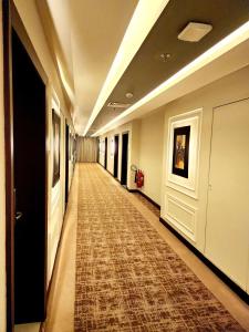 a long hallway with a rug on the floor at Best Western Premier Hotel Gulberg Lahore in Lahore