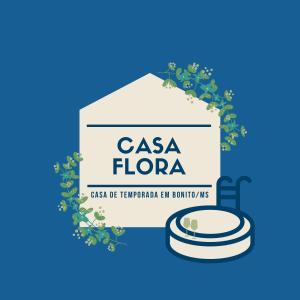 a label for a casa flora with a plate and aucer at Casa Flora - Jacuzzi exclusiva e conforto absoluto a 10 quadras da praça central in Bonito
