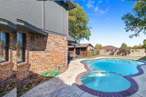 a swimming pool in front of a house at Pool & hot SPA & 5 bedroom 3 full bath in McKinney
