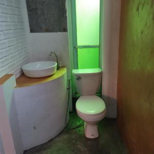 a bathroom with a toilet and a sink at Anodash Homestay in Baan Tai