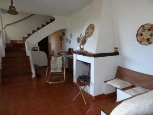 a living room with a fireplace and a staircase at Villa Liliana P9275 in Torre delle Stelle