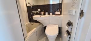 a small bathroom with a toilet and a sink at HOTEL LiVEMAX Akasaka GRANDE in Tokyo