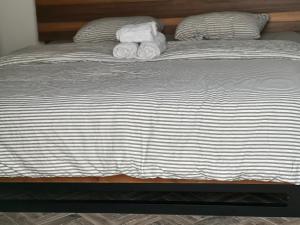a bed with two rolled up towels on it at Corcho rooms in Panama City