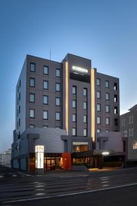 a building with two tall buildings in a city at LC Goryokaku Hotel in Hakodate