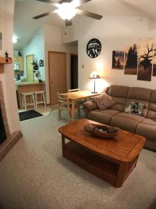 a living room with a couch and a coffee table at Cozy 2 BR Mountain View - walk to resort in Big Sky