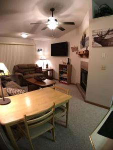 a living room with a table and a couch at Cozy 2 BR Mountain View - walk to resort in Big Sky