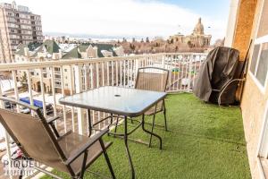 a table and chairs on a balcony with a view at Luxury Downtown Suite, River Valley View, Patio & BBQ, Sleeps 4 in Edmonton