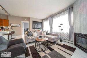 uma sala de estar com um sofá e uma lareira em Luxury Downtown Suite, River Valley View, Patio & BBQ, Sleeps 4 em Edmonton