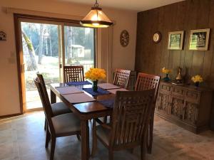 a dining room with a wooden table and chairs at Foothill Acres in Midpines