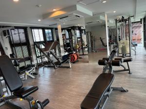 a gym with several treadmills and cardio machines at Phuket apartment surin beach in Thalang