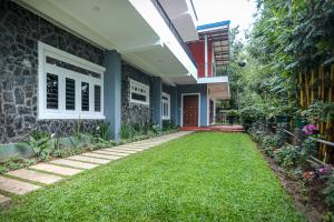a house with a lawn in front of it at Kandy Hub Guest House in Kandy