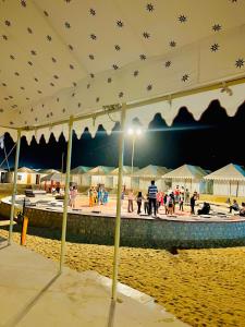 a group of people on a beach at night at Iceland Luxury Desert Camp in Sām