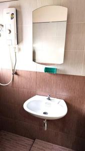 a bathroom with a white sink and a mirror at Big whole peaceful house in Udon Thani