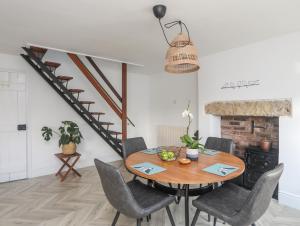 a dining room with a table and chairs at Disgwylfa in Moelfre