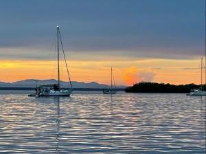 a group of boats in the water at sunset at Villa AMAYA in Bocas del Toro