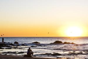 - une personne assise sur la plage pour admirer le coucher du soleil dans l'établissement Jade Coast #3- Private 5 Bedroom Villa, à Tamarindo