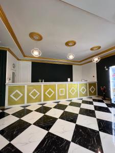 a room with a black and white checkered floor at Гостиница Селена in Qyzylorda