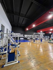 a gym with rows of machines and a wooden floor at Гостиница Селена in Qyzylorda