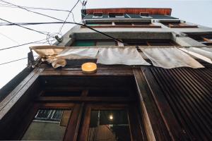 a building with a laundry hanging off the side of it at Machiya Hinoki in Tainan