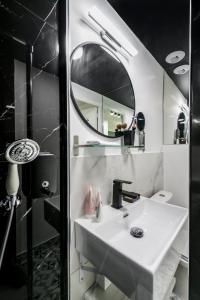 a bathroom with a white sink and a mirror at Apartments WS Opéra - Laffitte in Paris