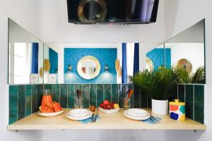 a counter with plates and bowls of fruit on it at Apartments WS Opéra - Laffitte in Paris