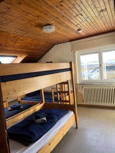 two bunk beds in a room with a wooden ceiling at Vesperstube Michelbach in Gaggenau