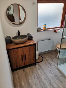 a bathroom with a sink and a mirror at _Linstant_zen_ in Saint-Just