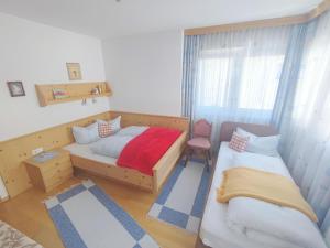 a bedroom with two beds and a chair in it at Great holiday home in Hippach with sunny terrace in Hippach