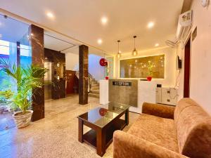 a living room with a couch and a table at Hotel Prayag INN Haridwar in Haridwār