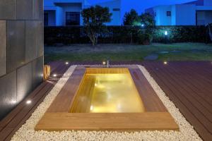 a swimming pool in the middle of a backyard at night at Velum Resort in Seogwipo