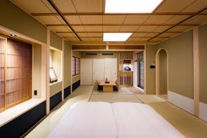 a hospital hallway with a bed and a table at Ishibekoji Muan in Kyoto