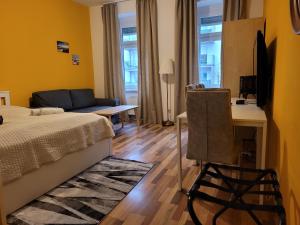 a bedroom with a bed and a desk with a computer at Leopoldauer Apartment in Vienna