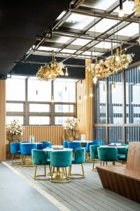 a dining room with blue tables and blue chairs at HOTEL LEISURE Kaohsiung in Kaohsiung